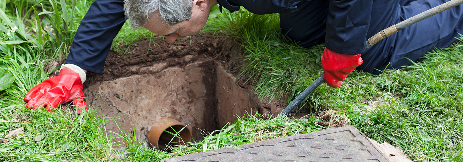 Plumber Cleaning A Sewer Drain