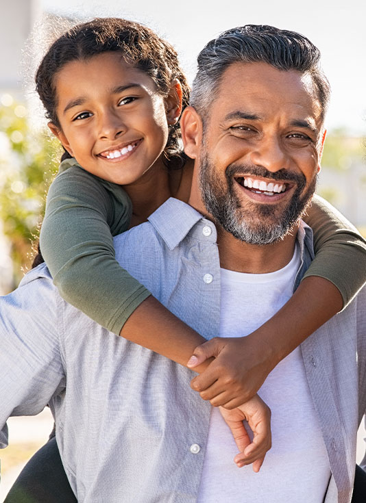 Father and daughter smiling
