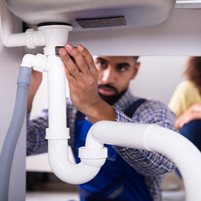 Plumbing expert examining pipe