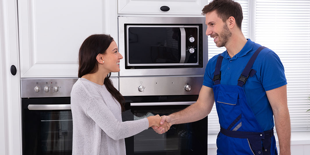 client and plumber shaking hands