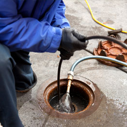 Plumber Inspecting Pipe With Camera