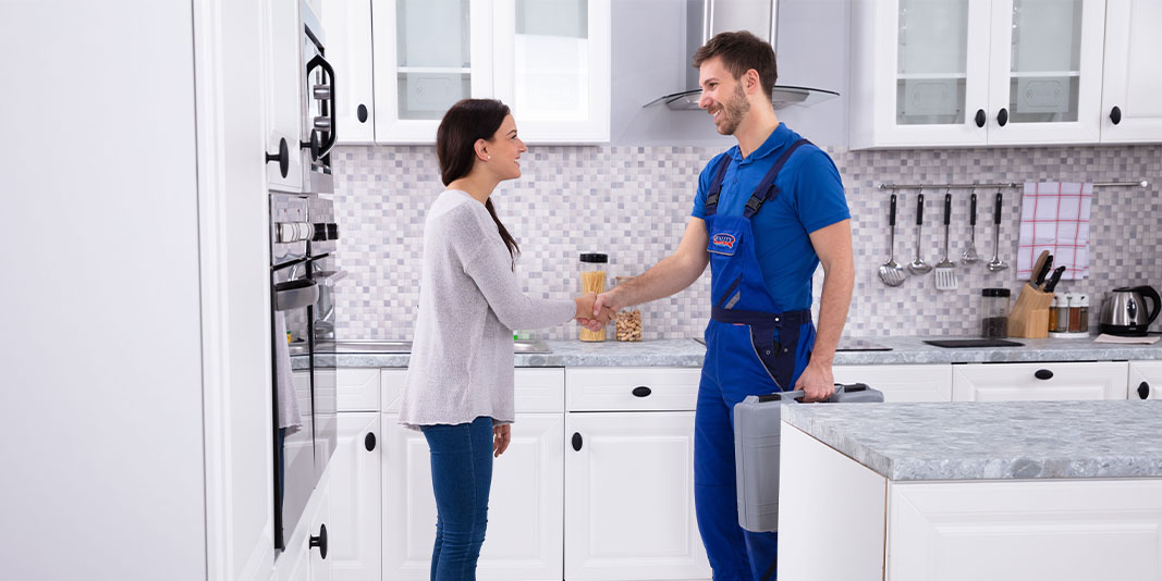 Plumber Shaking Hand With Client