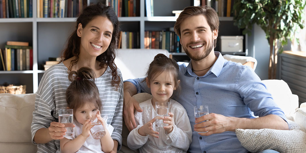 Young family sitting together on a couch